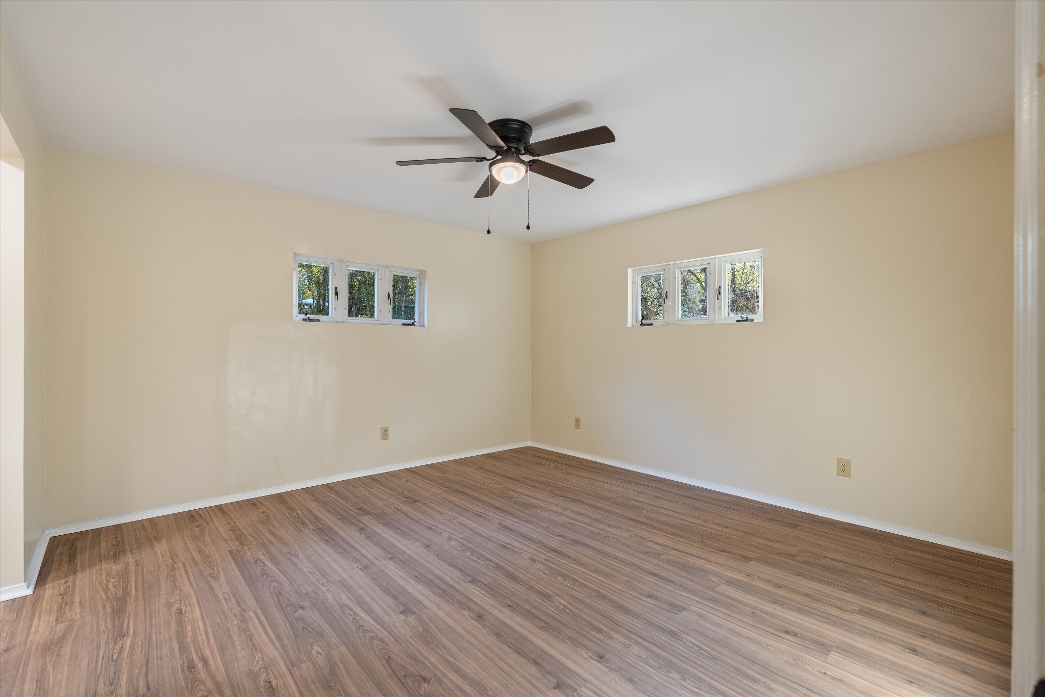 31 Volunteer Circle Carthage, TN 37030 - Photo 30 of 52 an empty room with wooden floor ceiling fan and windows