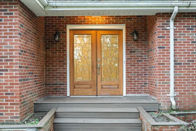 a view of front door of house with stairs