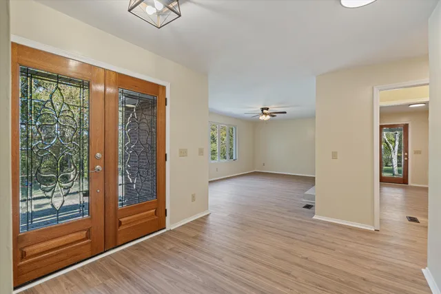 a living room with furniture a clock and a fireplace