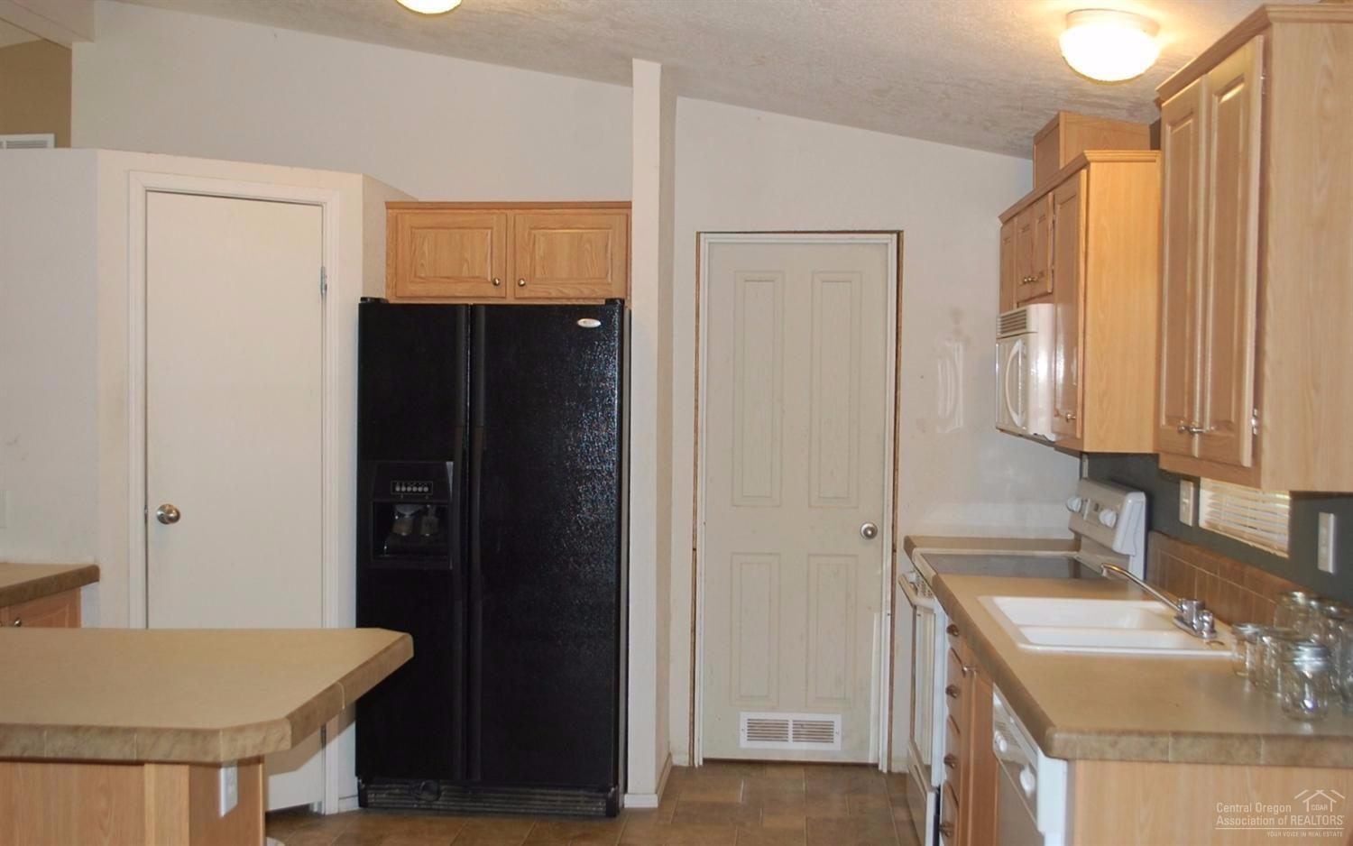 62255 Cody Road Bend, OR 97701 - Photo 5 of 11 Pantry on left. Door leads to utility r