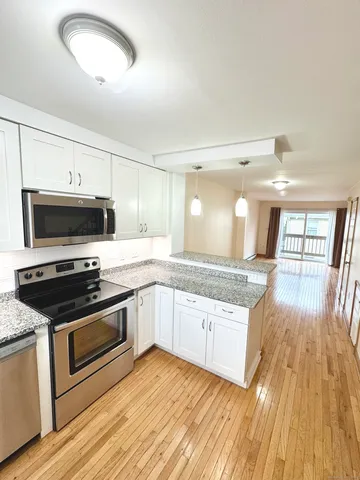 a kitchen with granite countertop a stove and a sink