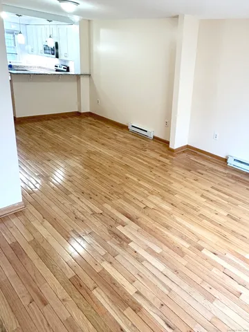 a view of a kitchen with wooden floor and a sink