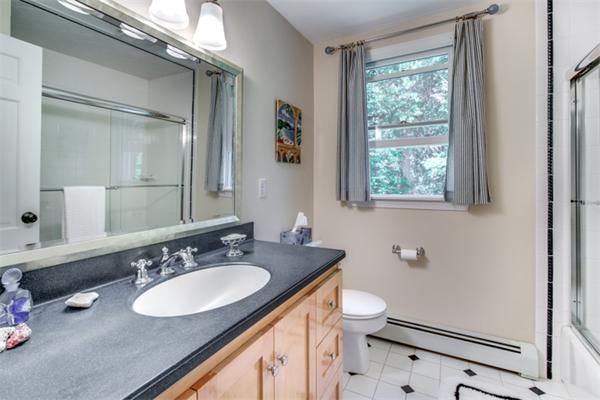 429 Linebrook Road Ipswich, MA 01938 - Photo 23 of 30 a bathroom with a granite countertop sink a toilet a mirror and a window