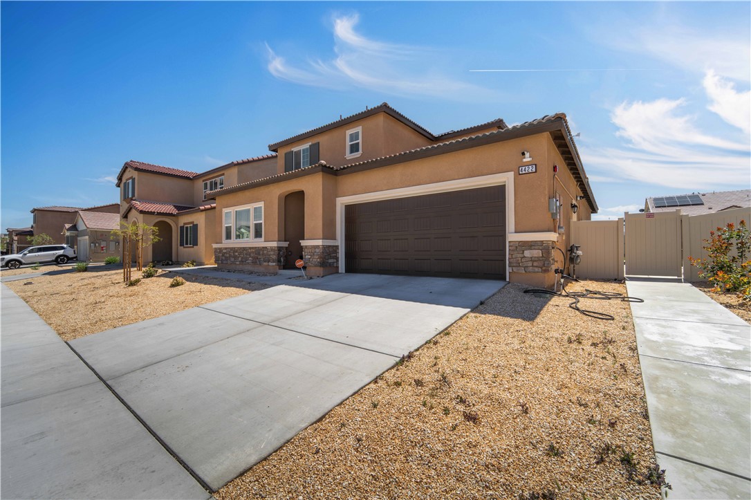 4422 Jade Court Lancaster, CA 93536 - Photo 11 of 44 a front view of a house with a yard