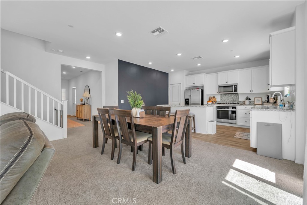 4422 Jade Court Lancaster, CA 93536 - Photo 25 of 44 a large kitchen with a table and chairs