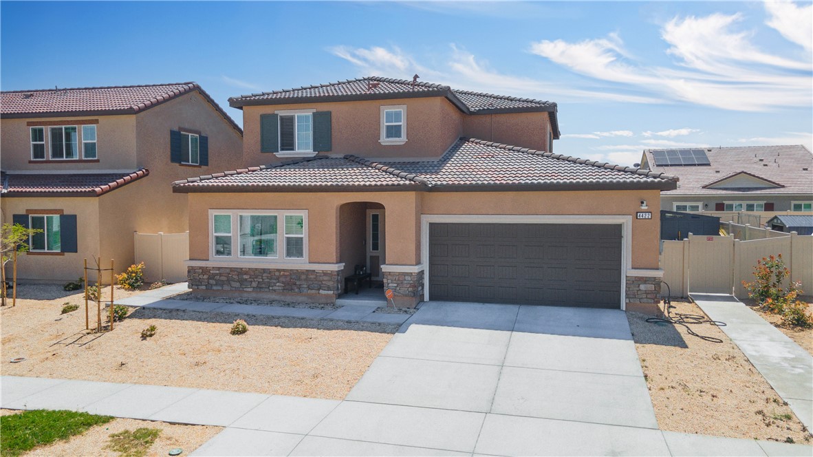 4422 Jade Court Lancaster, CA 93536 - Photo 3 of 44 a front view of a house with a yard and garage