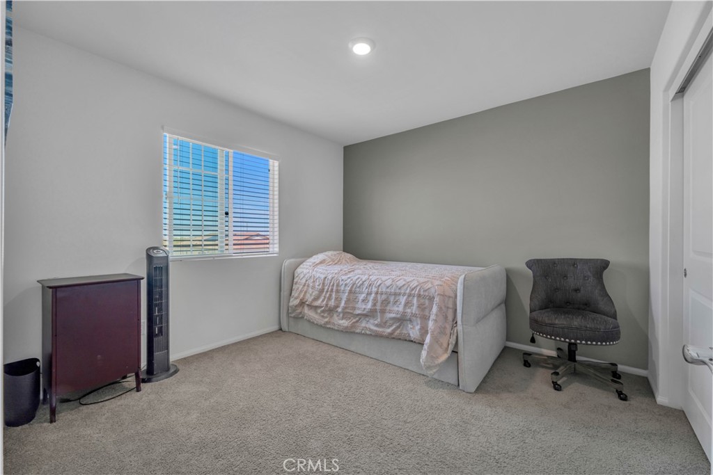 4422 Jade Court Lancaster, CA 93536 - Photo 33 of 44 a bedroom with a bed and a chair