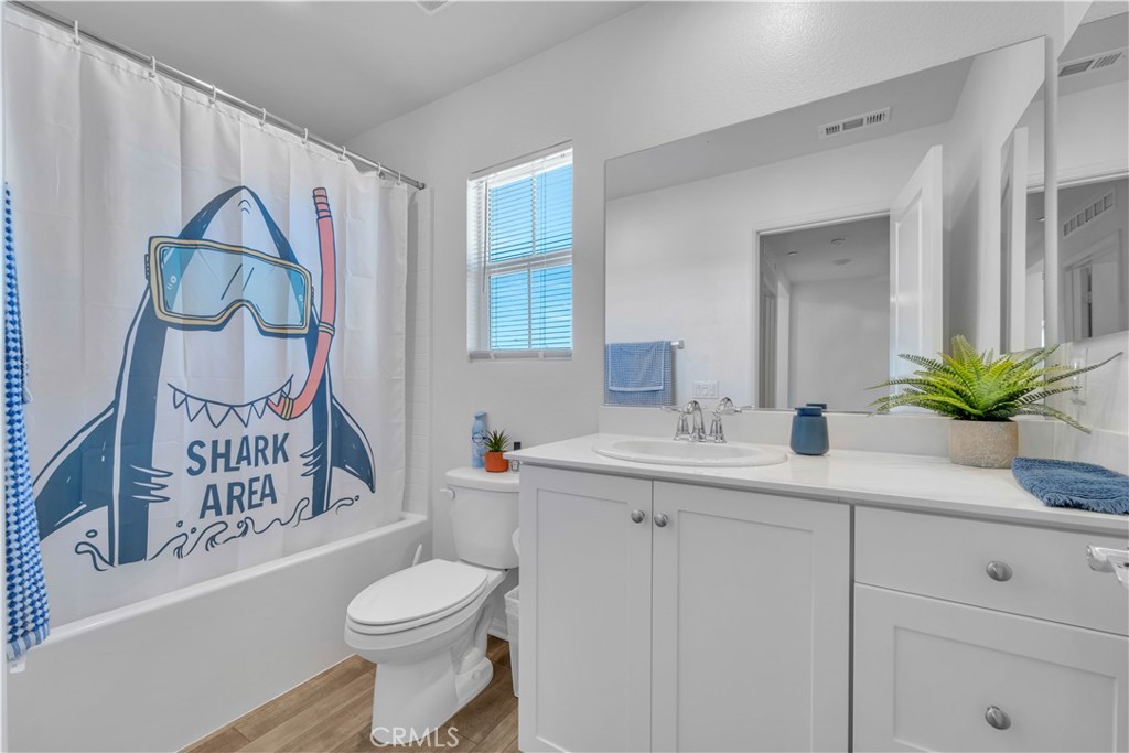 4422 Jade Court Lancaster, CA 93536 - Photo 34 of 44 a bathroom with a toilet sink and mirror