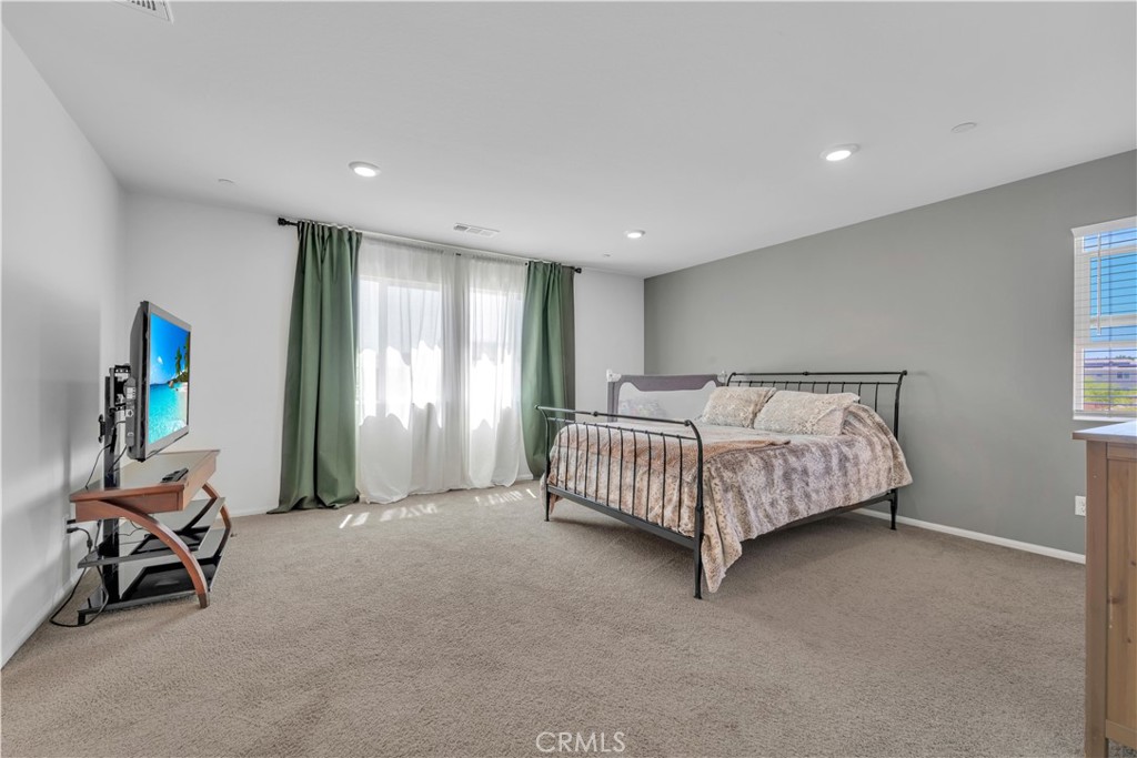 4422 Jade Court Lancaster, CA 93536 - Photo 35 of 44 a bed room with a bed and a chair