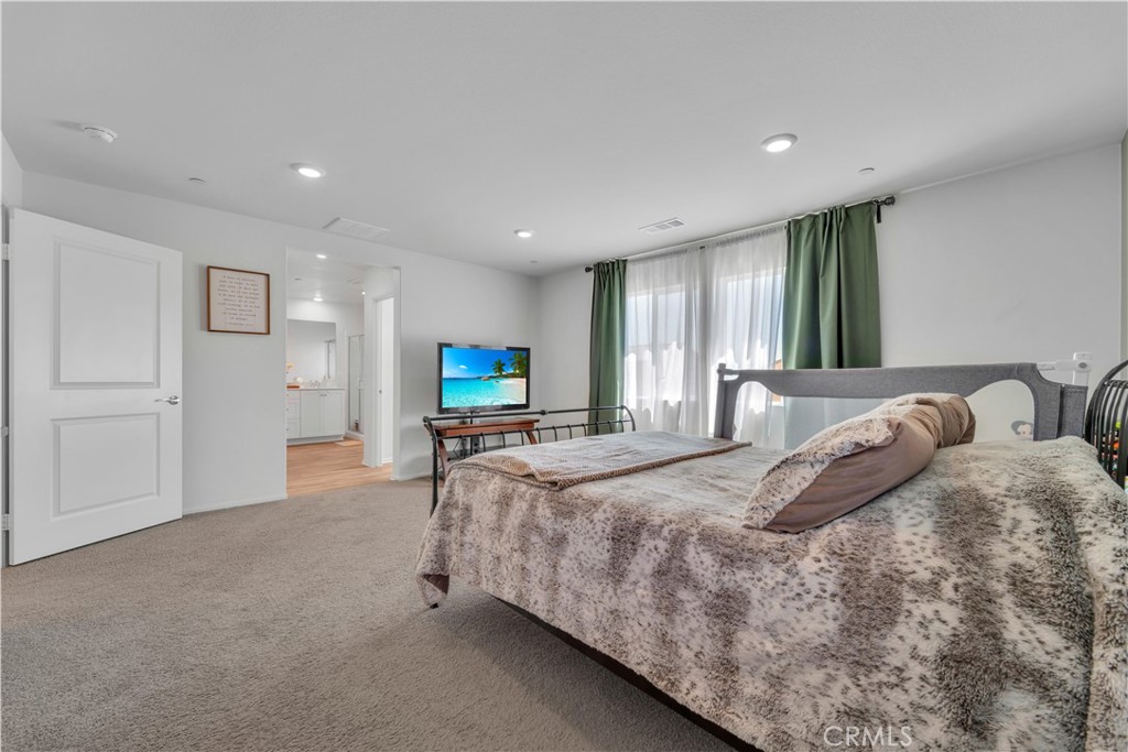 4422 Jade Court Lancaster, CA 93536 - Photo 36 of 44 a bed room with a bed furniture and a tv