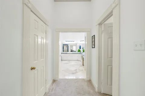 a bathroom with a tub a sink and a mirror