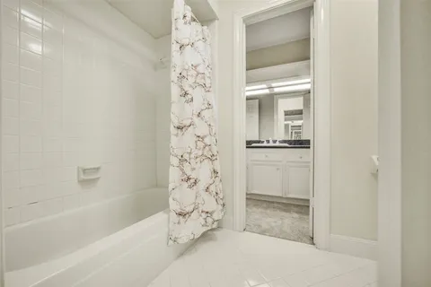 a bathroom with a granite countertop sink and mirror