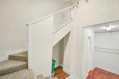 a storage and utility room with wooden floor