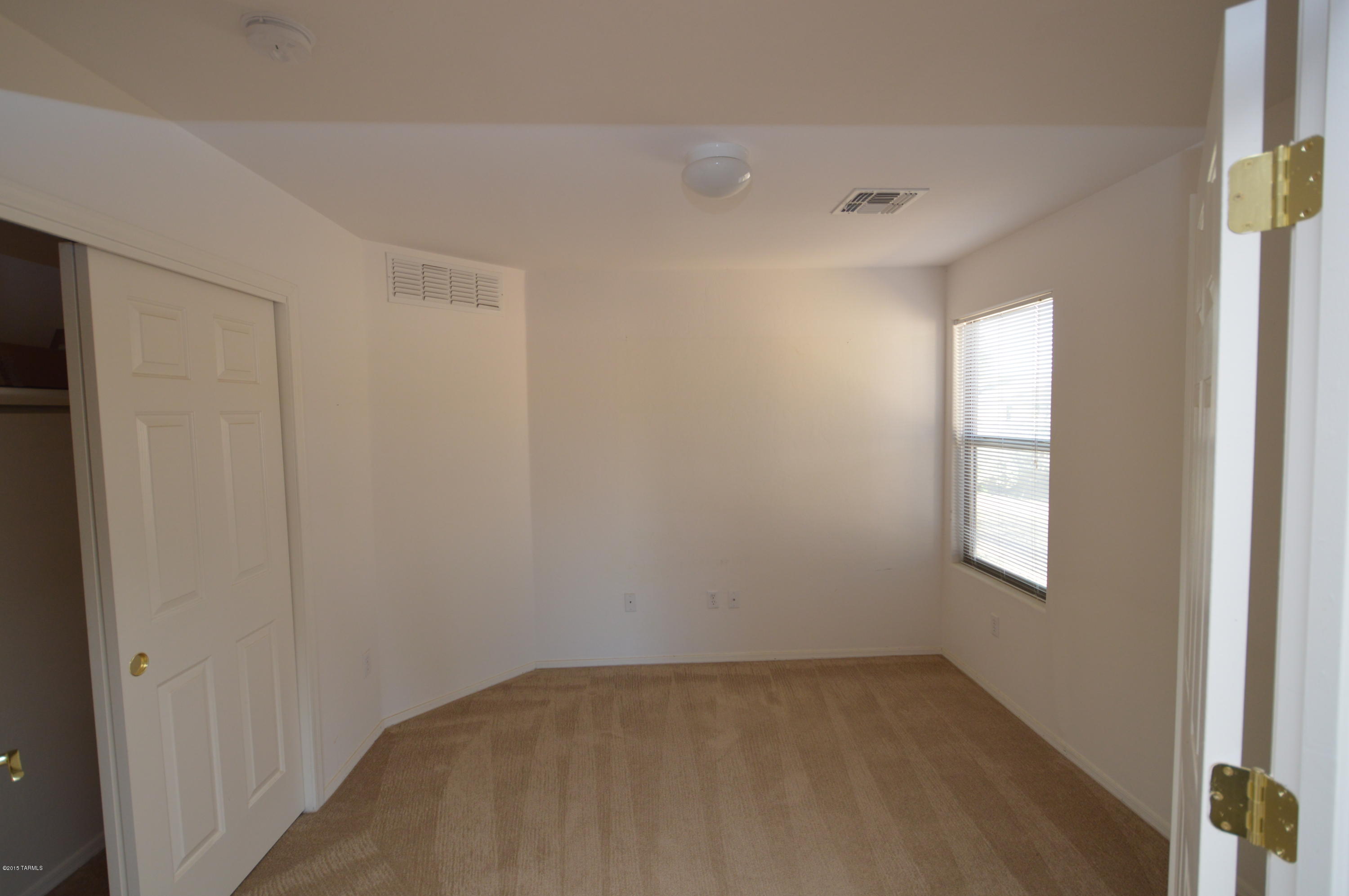 8396 West Benidorm Loop Tucson, AZ 85757 - Photo 9 of 13 an empty room with windows