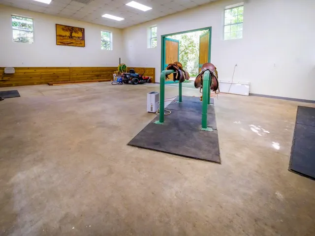 a living room with furniture and a pool table