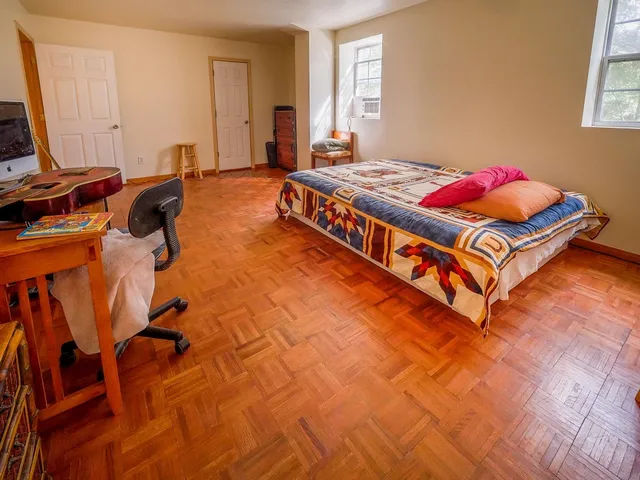 a bed room with a bed and a book shelf