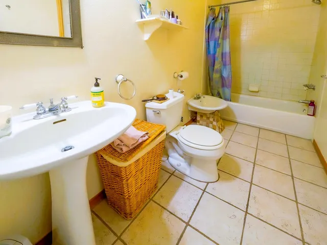 a backyard of a house with barbeque oven table and chairs