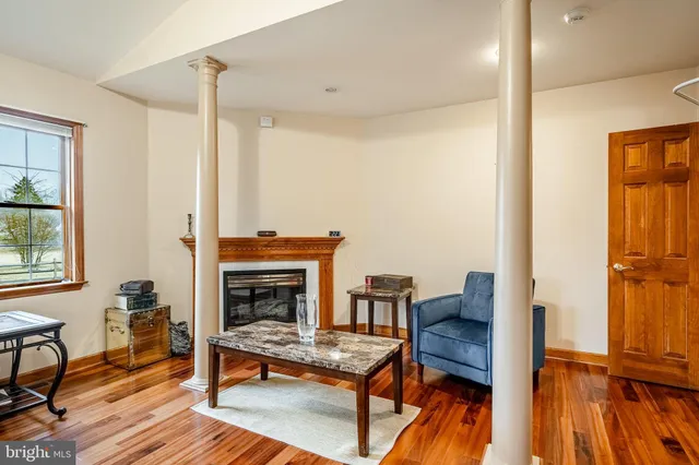 a living room with furniture fireplace and wooden floor