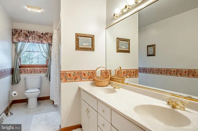 a bathroom with a toilet and a shower curtain