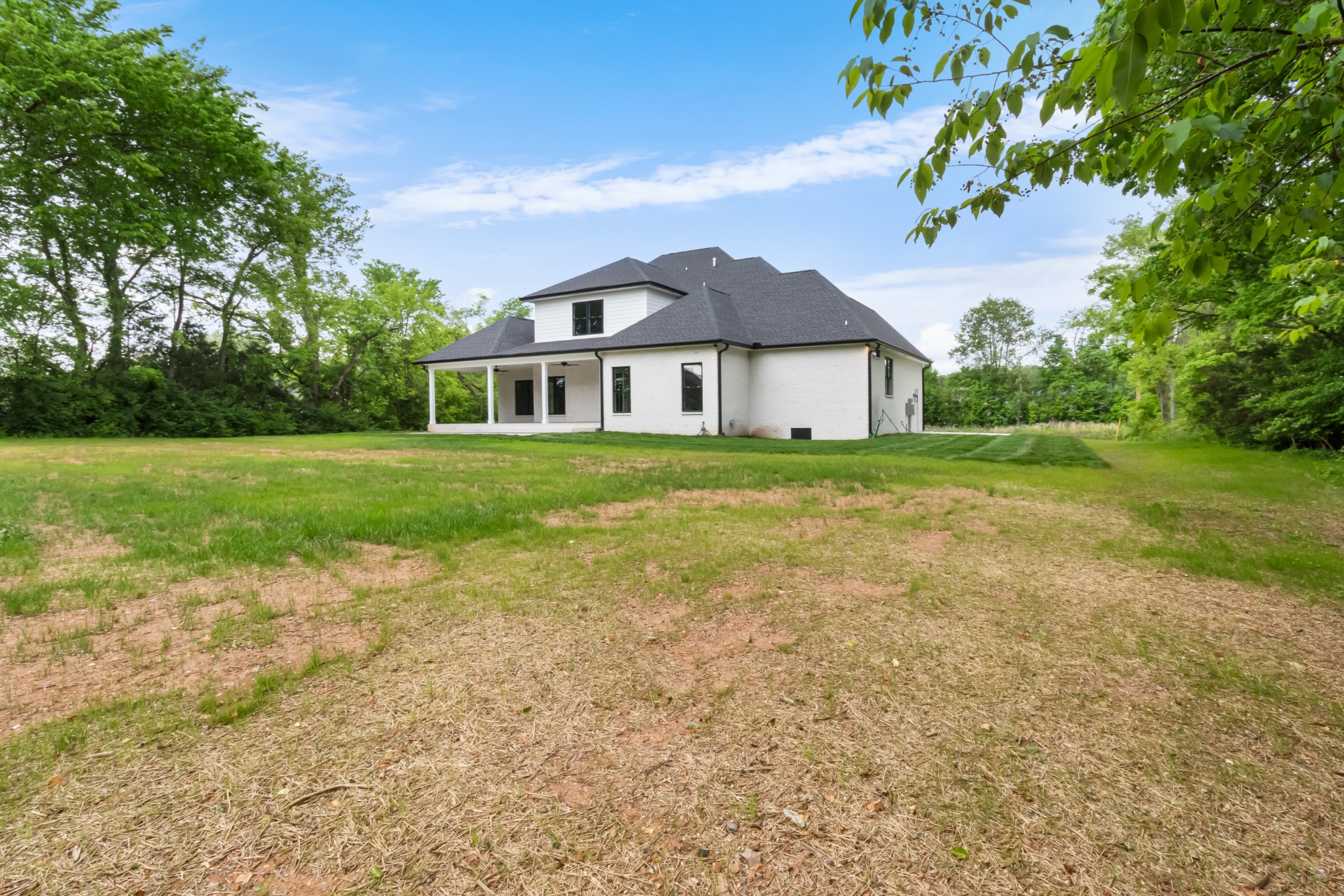 3600 Trough Springs Road Adams, TN 37010 - Photo 50 of 54 a view of a big house with a big yard and large trees