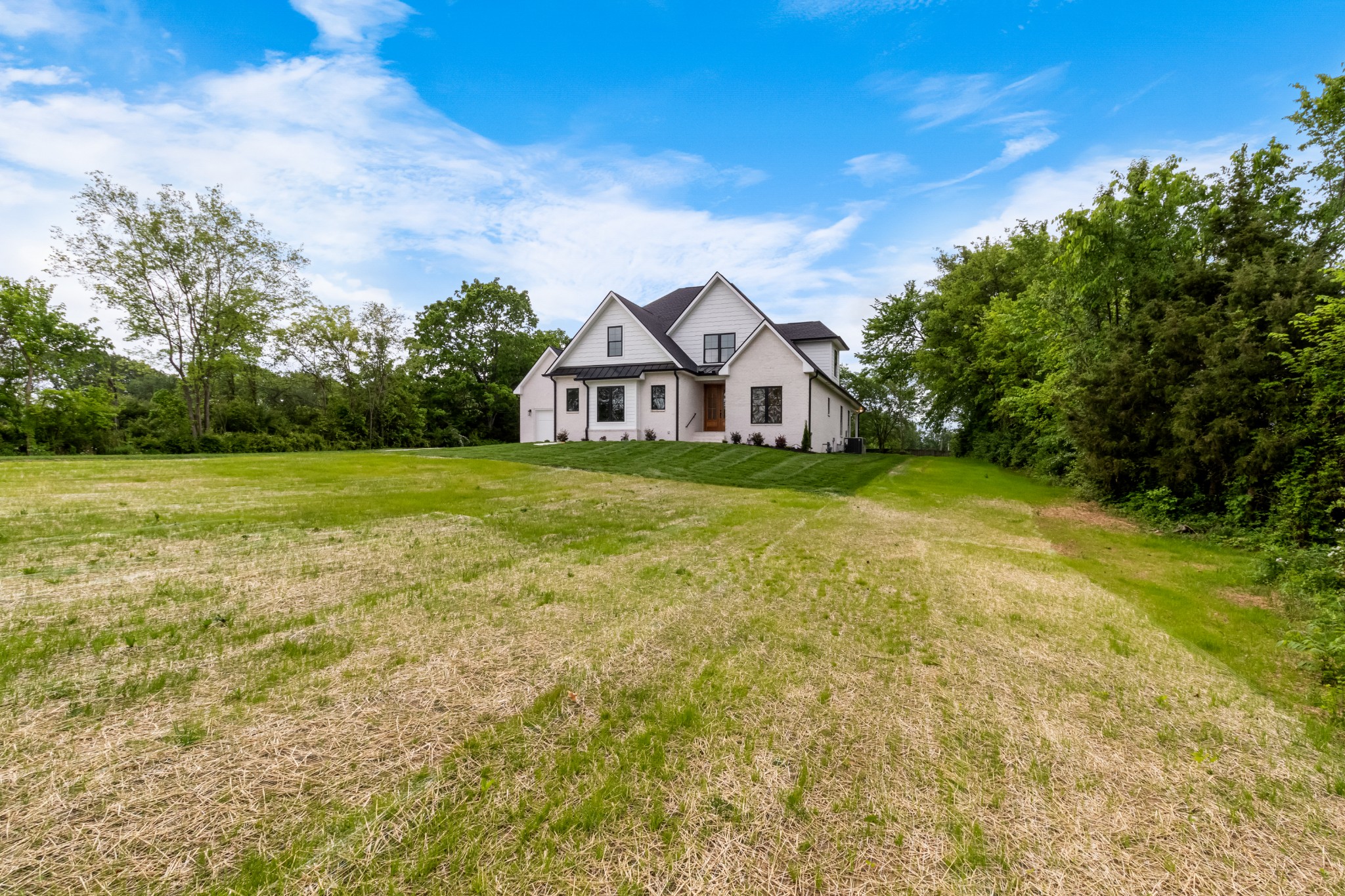 3600 Trough Springs Road Adams, TN 37010 - Photo 5 of 54 a view of a big house with a big yard and large trees