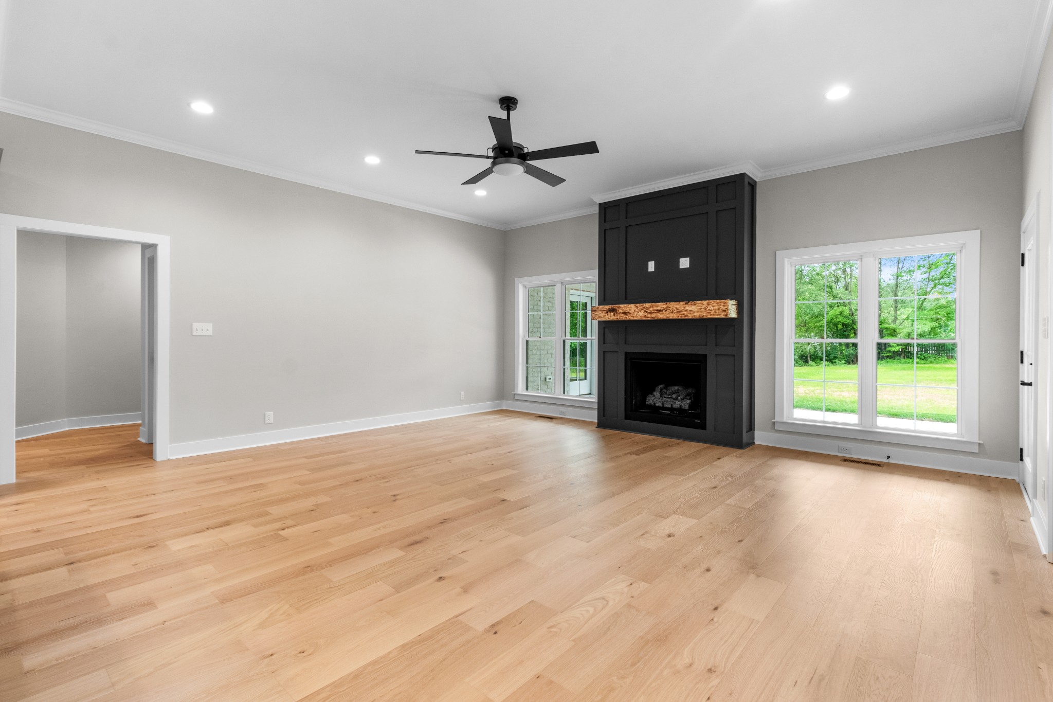 3600 Trough Springs Road Adams, TN 37010 - Photo 10 of 54 a view of empty room with wooden floor fireplace and window