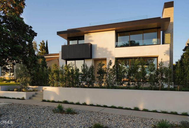 a living room with furniture a fireplace and floor to ceiling window