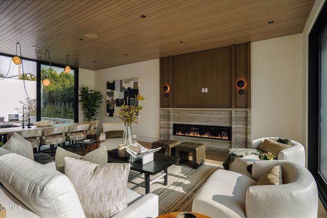 a kitchen with a table chairs sink and cabinets