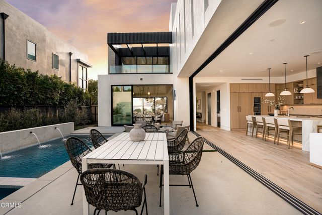a living room with lots of furniture and next to a window