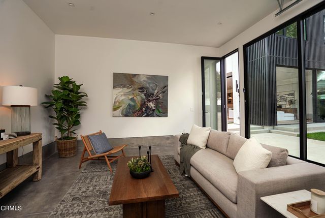 an aerial view of a house with garden space and wooden fence