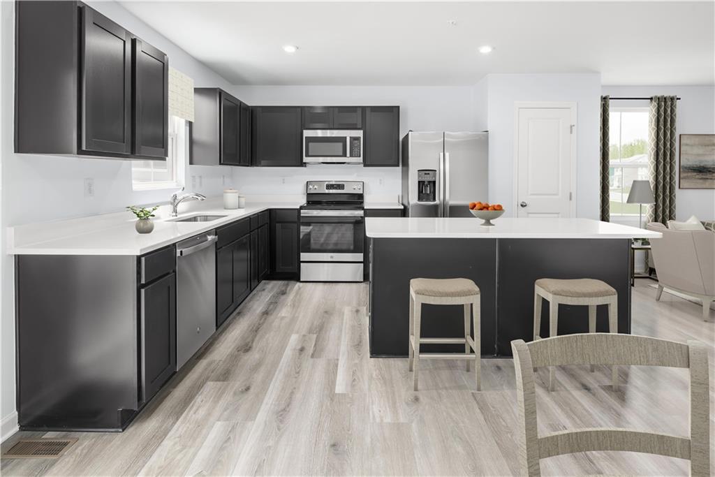 101 Walk Off Way Butler, PA 16001 - Photo 4 of 11 a kitchen with a sink refrigerator and microwave