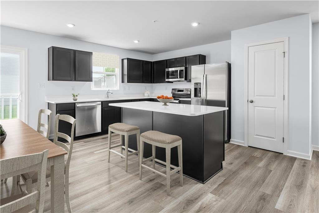 101 Walk Off Way Butler, PA 16001 - Photo 5 of 11 a large kitchen with stainless steel appliances a stove a sink a refrigerator and chairs