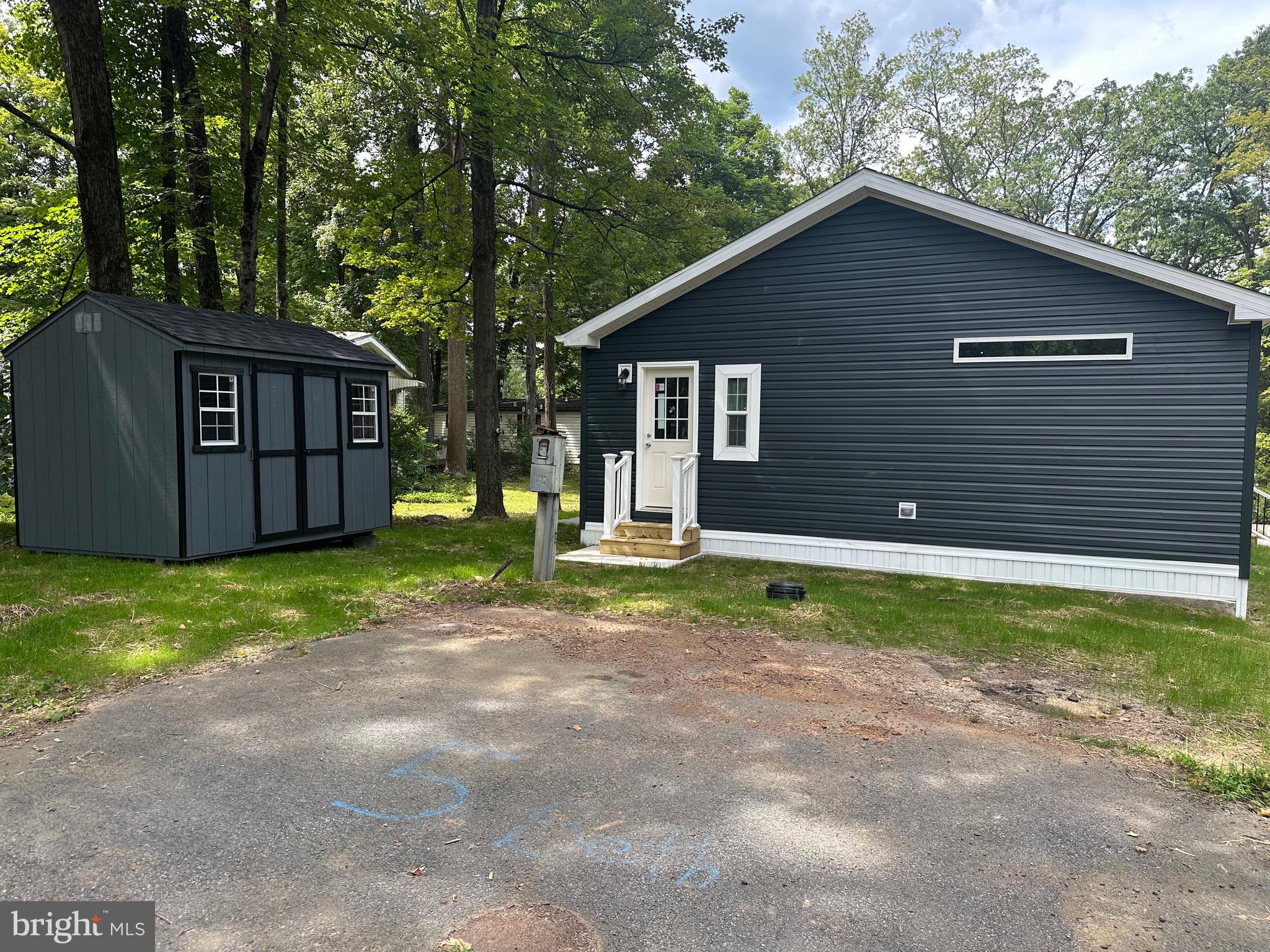 5 Beth Lane Quakertown, PA 18951 - Photo 2 of 12 a backyard of a house with wooden fence and large trees