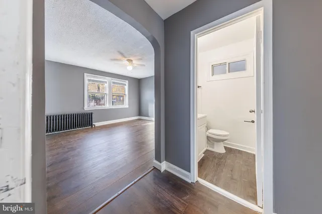 a view of a room with wooden floor and a window