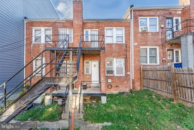 a front view of a building with a garden