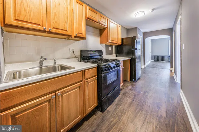 a kitchen with stainless steel appliances granite countertop a sink and a stove