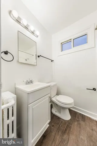 a bathroom with a toilet sink and mirror