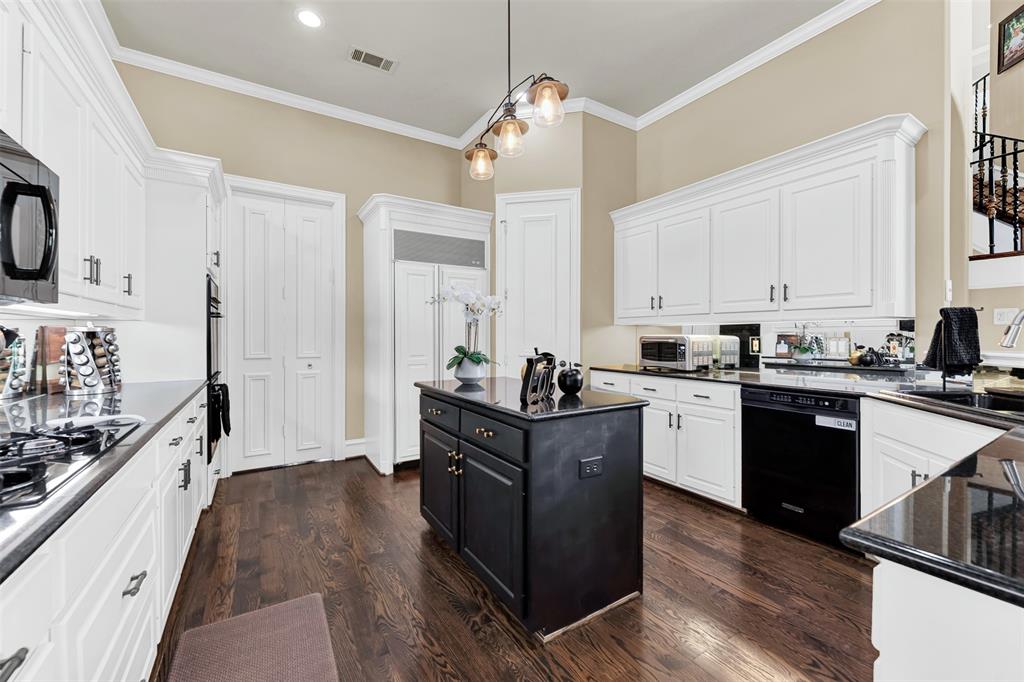 2605 Rutgers Court Plano, TX 75093 - Photo 16 of 34 Your dream kitchen awaits! Doors at the end lead to the formal dining room, and you'll love the abundant cabinet and counter space, plus the built-in fridge and walk-in pantry!