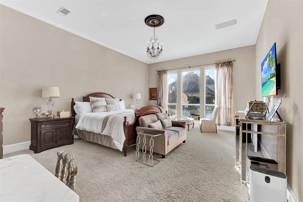 2605 Rutgers Court Plano, TX 75093 - Photo 21 of 34 Welcome to your private retreat! The primary bedroom is off the living room for ultimate privacy, yet large windows let you keep tabs on the pool and backyard. Like the other rooms, the bedroom features a surround sound system, plus elegant crown molding.