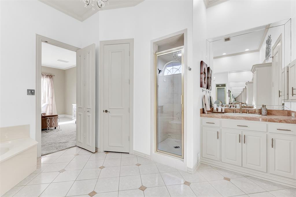 2605 Rutgers Court Plano, TX 75093 - Photo 24 of 34 The primary bath has a separate walk-in shower plus additional storage closet and intricate tiled floor.