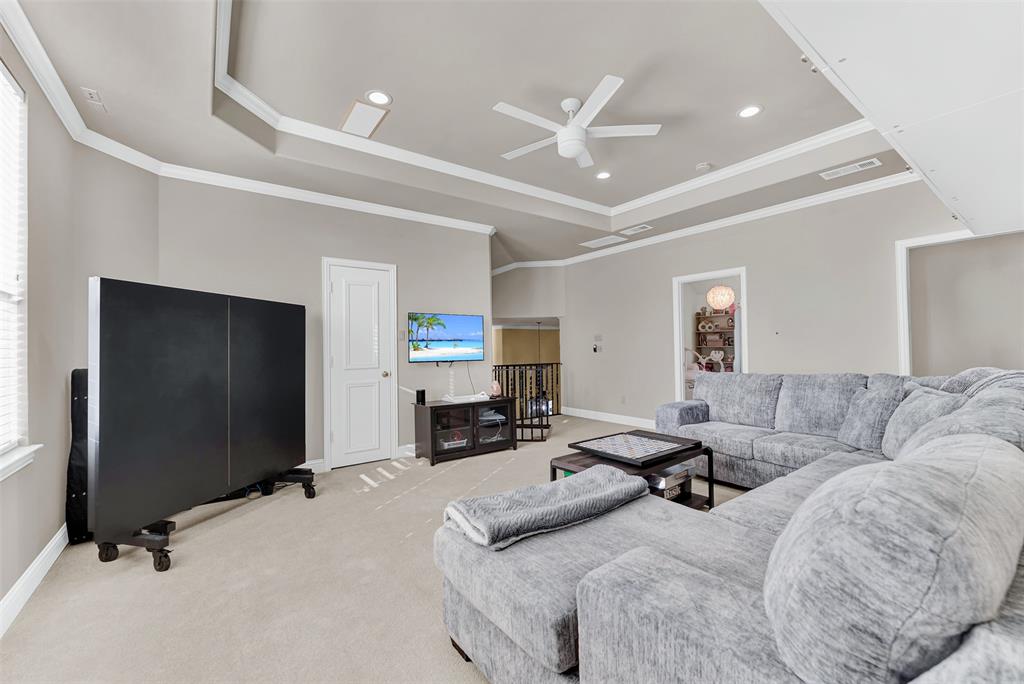 2605 Rutgers Court Plano, TX 75093 - Photo 26 of 34 This space is so versatile! Big enough for a pool table (or ping pong table), the game room features a tray ceiling and more crown molding.