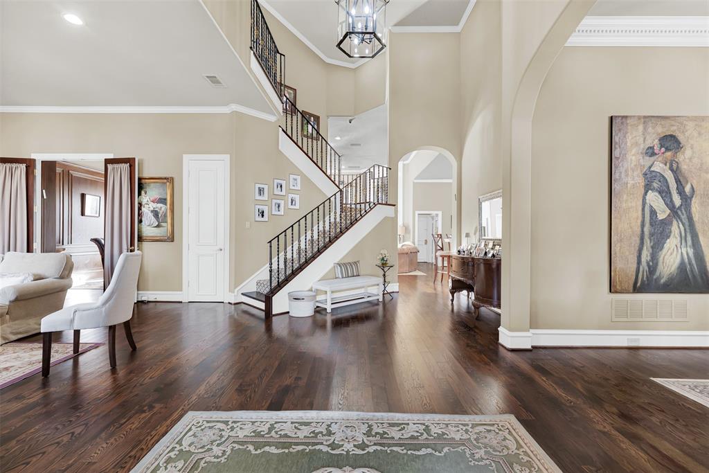 2605 Rutgers Court Plano, TX 75093 - Photo 5 of 34 The foyer leads directly past the stairs with a custom railing to the family room and kitchen area, with access to the pool and backyard!