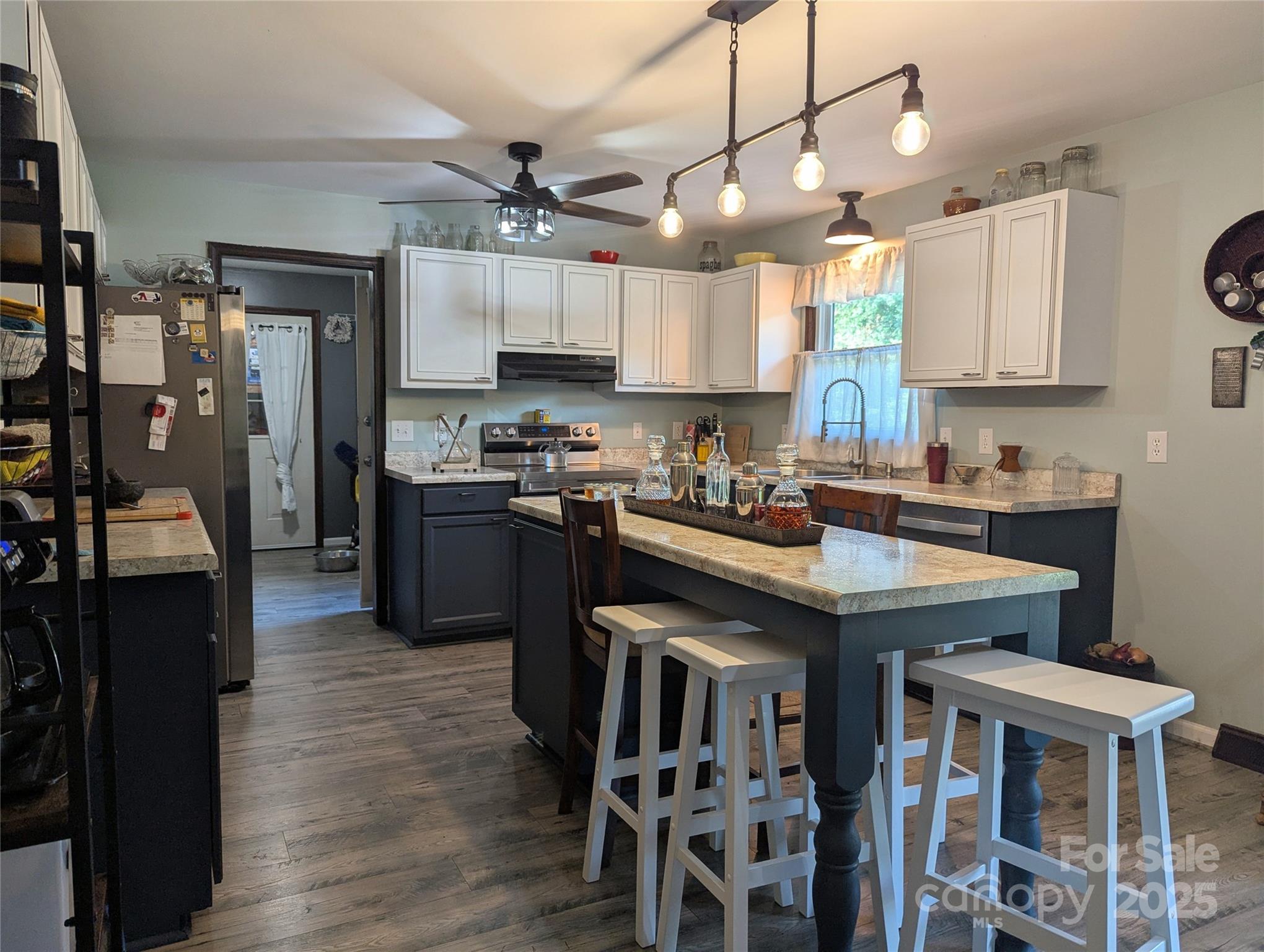 3080 Shue Road Salisbury, NC 28147 - Photo 23 of 38 a kitchen with stainless steel appliances granite countertop a table chairs refrigerator and sink