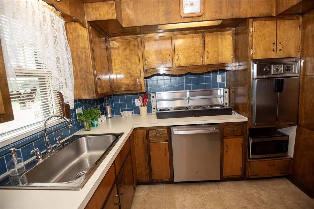 706 Stones Crossing Road Easton, PA 18045 - Photo 9 of 40 A classic kitchen with wood cabinetry and contrasting blue tile backsplash.