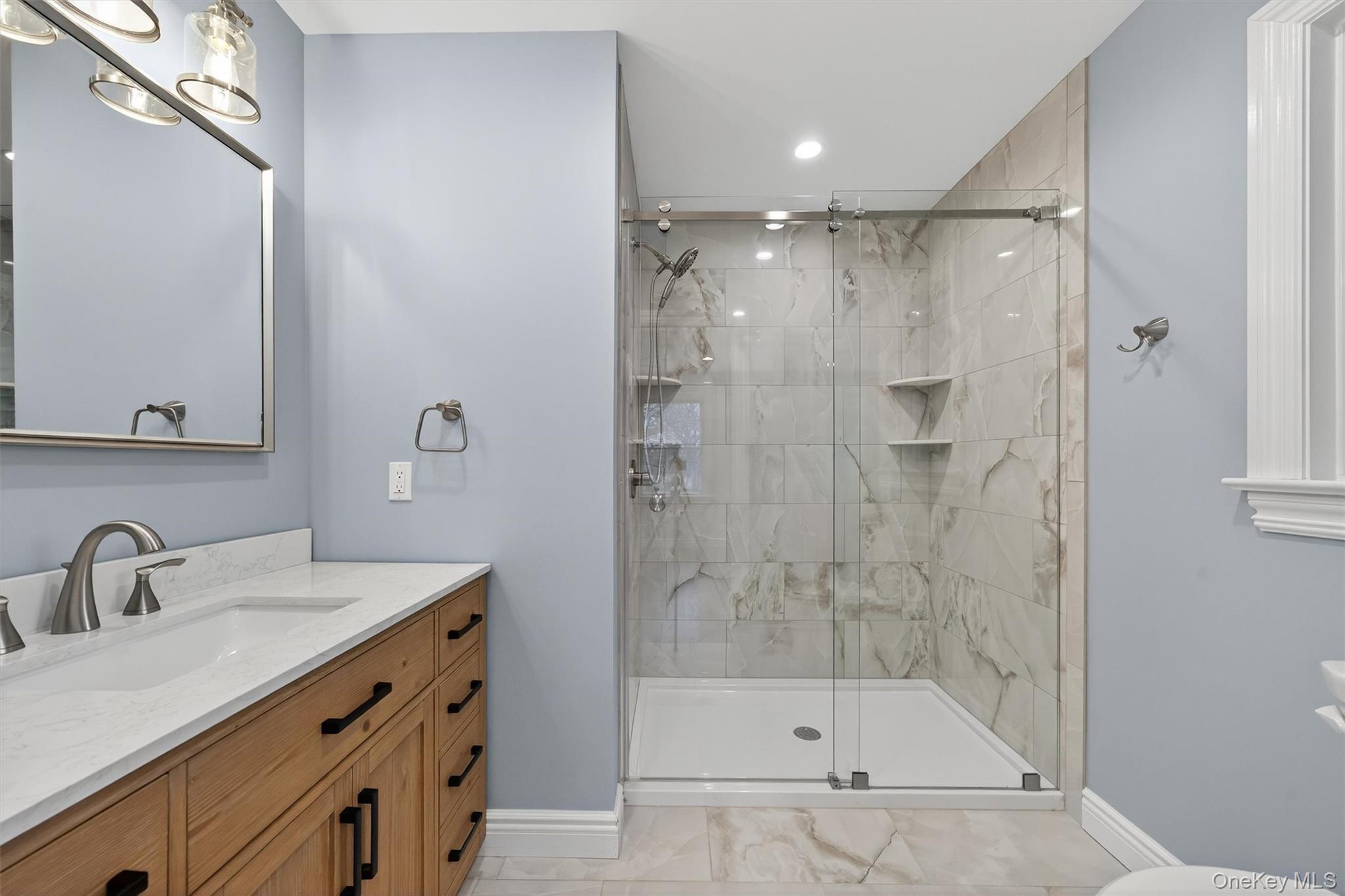 3 Little York Road Warwick, NY 10990 - Photo 23 of 39 a bathroom with a shower sink and mirror