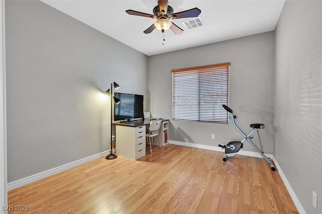 10983 Pumpkin Ridge Avenue Las Vegas, NV 89135 - Photo 19 of 35 Workout area featuring a ceiling fan, baseboards, visible vents, and light wood finished floors