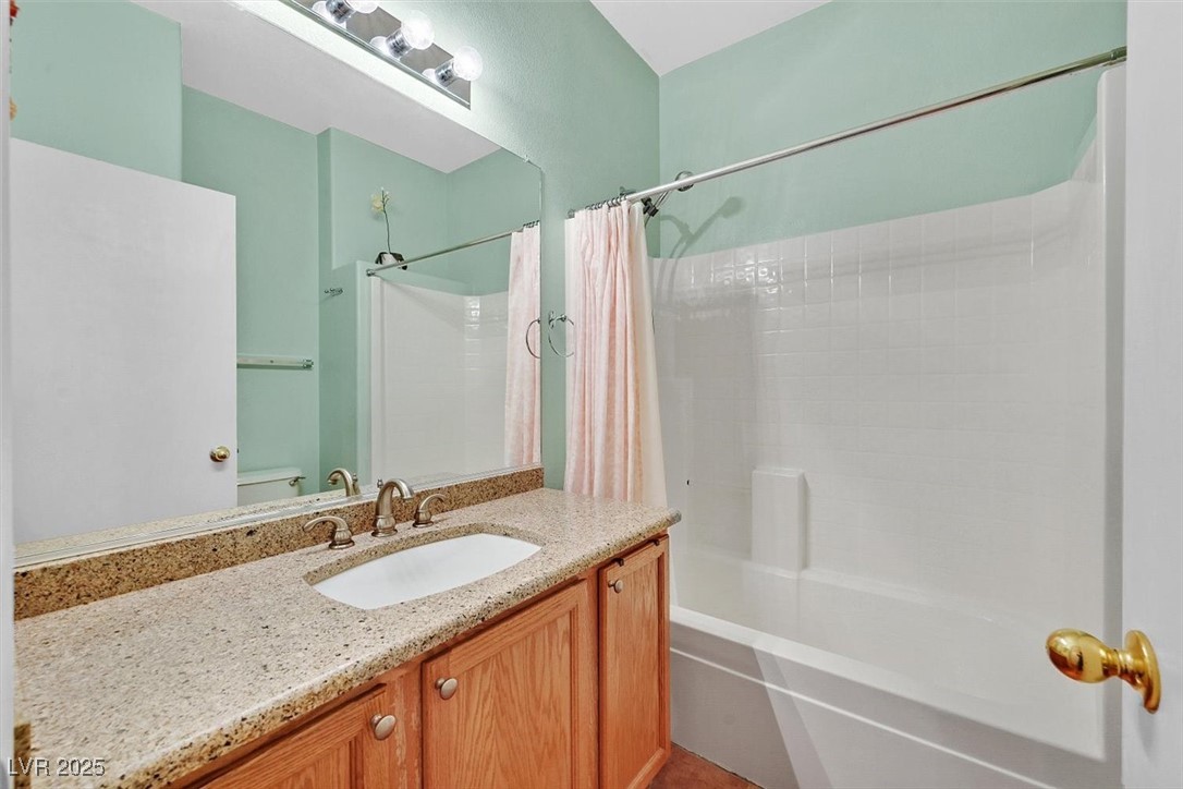 10983 Pumpkin Ridge Avenue Las Vegas, NV 89135 - Photo 21 of 35 Bathroom with toilet, shower / tub combo with curtain, and vanity