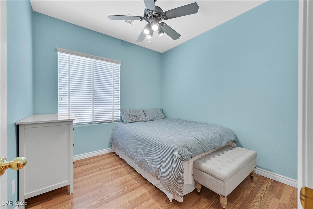 10983 Pumpkin Ridge Avenue Las Vegas, NV 89135 - Photo 23 of 35 Bedroom with ceiling fan, light wood-type flooring, and baseboards