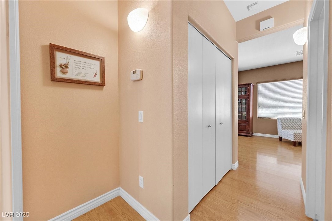 10983 Pumpkin Ridge Avenue Las Vegas, NV 89135 - Photo 24 of 35 Hall with baseboards and light wood finished floors