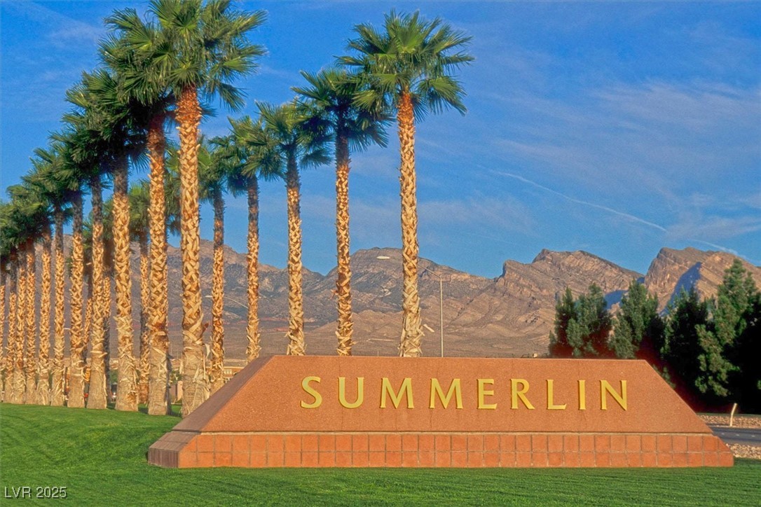 10983 Pumpkin Ridge Avenue Las Vegas, NV 89135 - Photo 31 of 35 Community / neighborhood sign with a mountain view and a lawn